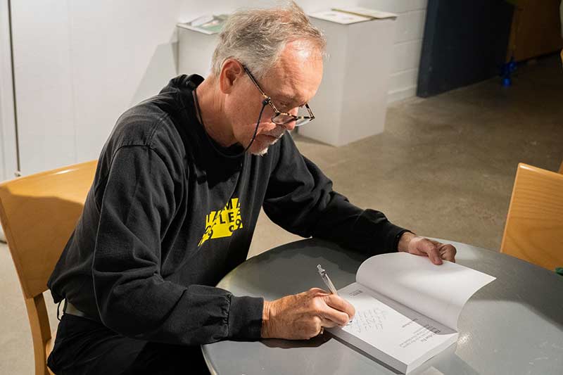 Doug Kelbaugh signing a book